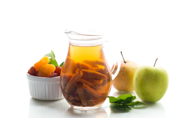 Traditional fruit drink on a wooden table, isolated on white background.