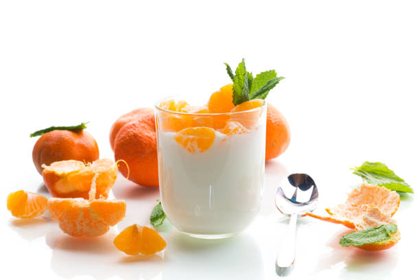 istock Creamy yogurt with tangerine slices, isolated on white background 2197847372