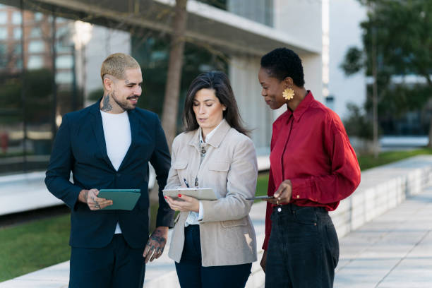 istock Business team discussing work using digital tablet outdoors 2197848930