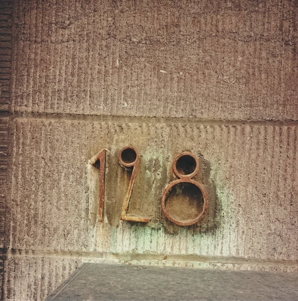House number one hundred twenty eight (128) with an unusual design and rusty metal