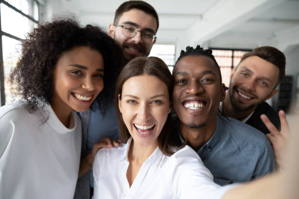 istock Smiling multiethnic colleagues make selfie in office together 2197854042