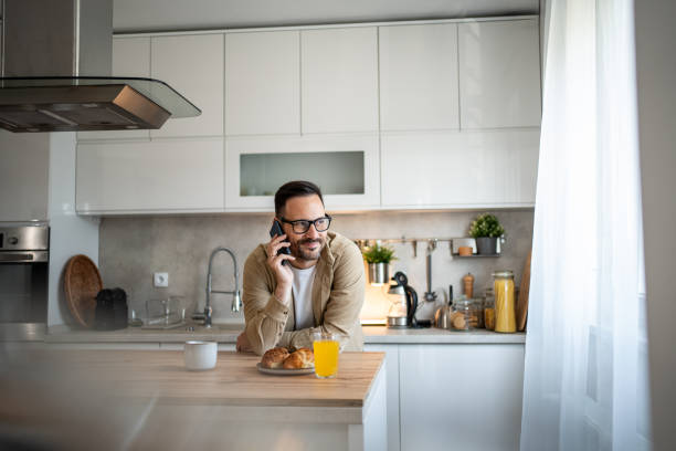 istock Man having a phone call and enjoying his croissants 2197855398
