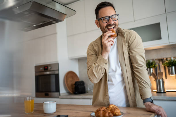 istock Delicious morning - Handsome man eating croissants 2197855819