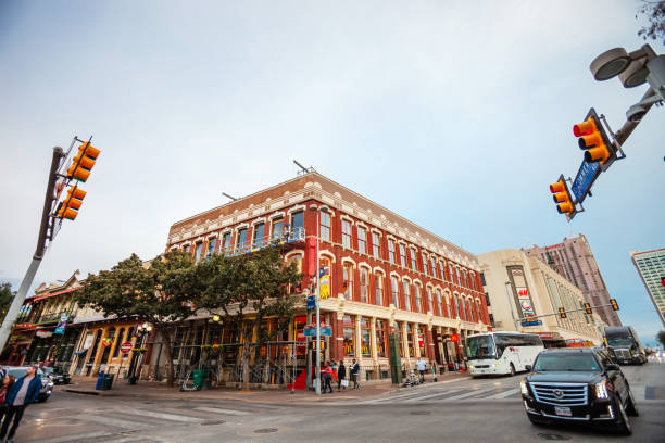 San Antonio, Texas, USA - Street view in downtown district with people and traffic just before sunset.