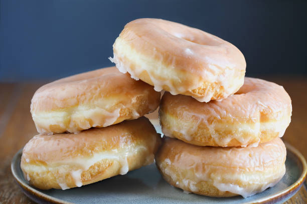 istock Plate of glazed donuts over a rustic background 2197858486