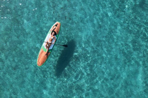 istock Girl on stand up paddle, SUP board paddling 2197859803