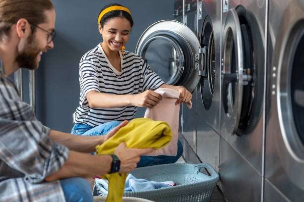 istock Couple in self-service laundromat doing their laundry 2197861272