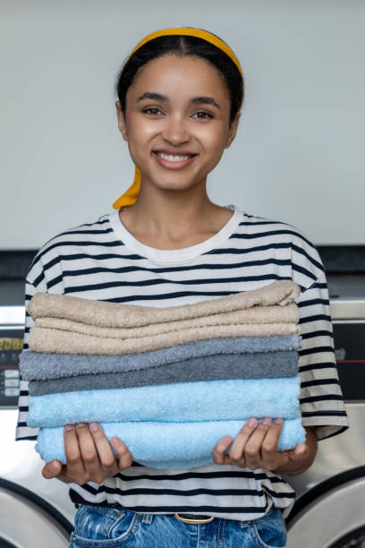 istock Female in laundromat after using washing machine for cleaning her towels 2197861421