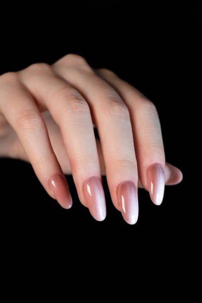 istock A hand with long extended nails coated with magnetic polish with a “cat-eye” effect creates a striking and stylish look. 2197861824
