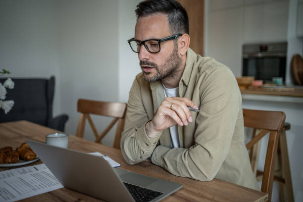 istock Serious businessman working from home 2197863236