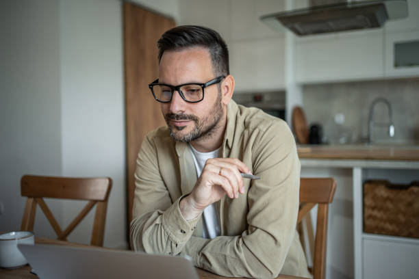 istock Serious businessman working from home 2197863237