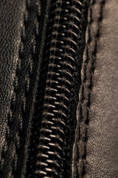 zipper for joining, which is used for the manufacture of shoes and other products, genuine leather painted black with seams, close up