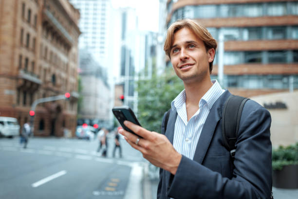 istock Young handsome businessman using smart phone outdoors in a city 2197869034
