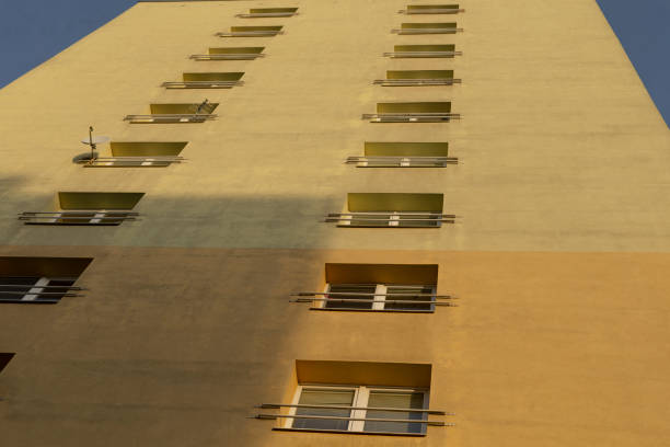 A very tall building featuring numerous windows set against a clear blue sky