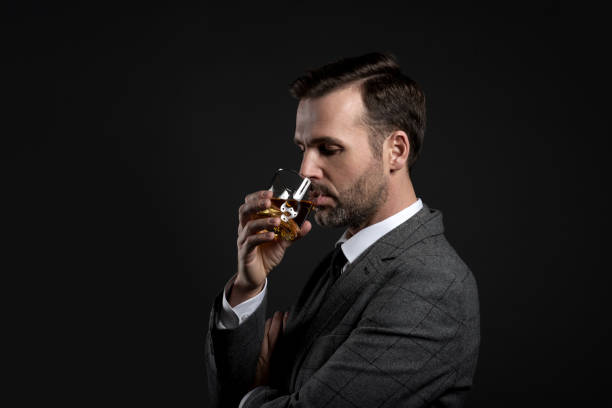 istock Portrait of elegant man drinking whiskey 2197872018