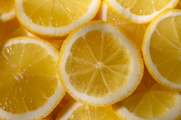 istock Bright yellow lemon slices arranged artistically, perfect for refreshing drink recipes or culinary delights 2197872299