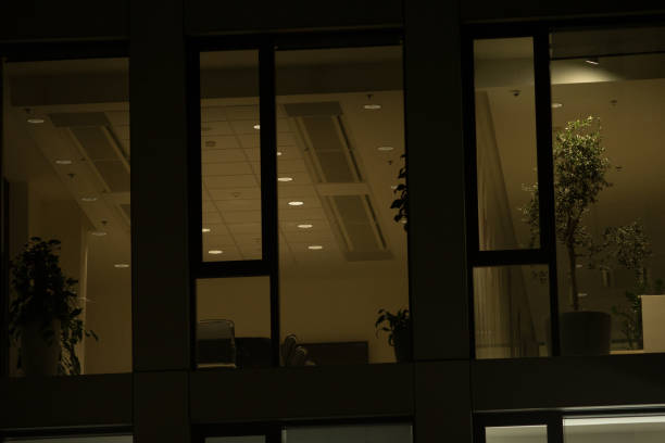 istock Office Building with Large Windows Viewed from Outside at Night 2197873013