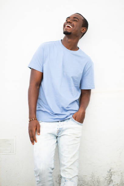 istock Stylish young black man smiling against white wall 2197877330