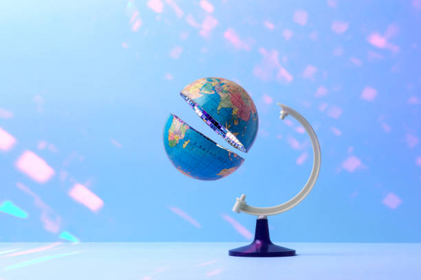 istock Sliced globe in half with mirrored disco ball inside on pastel blue background with glare. Creative concept of global celebration. Earth Day. 2197877662