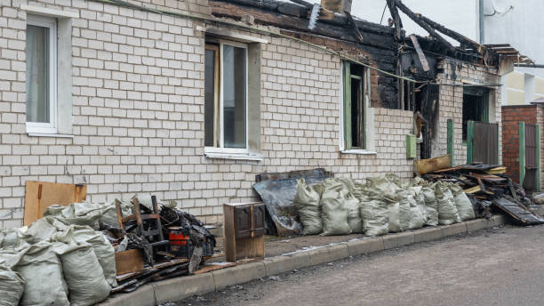 A devastated room with a door and a window, displaying signs of severe fire damage and destruction—an urgent case for expert Fire Damage Restoration services.