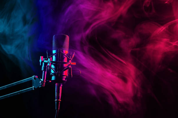 istock Professional microphone in pink smoke on a black background. 2197878572