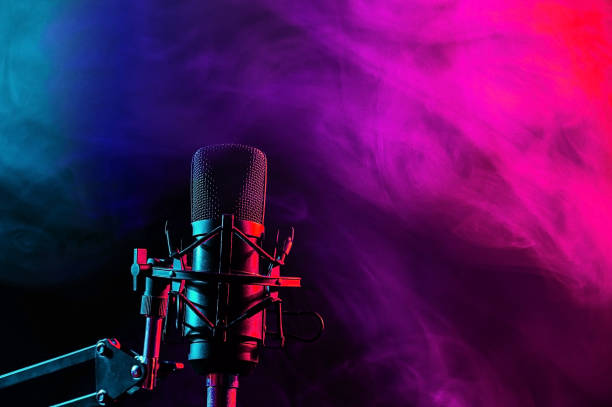 istock Professional microphone in pink smoke on a black background. 2197879333