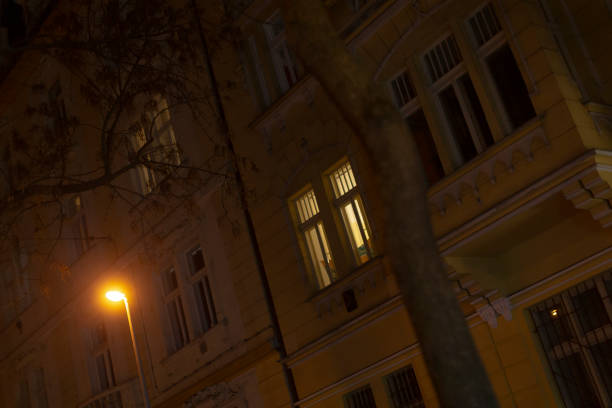 istock A tall building with many windows is brightly lit at night 2197879416