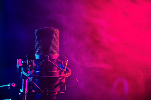 istock Professional microphone in pink smoke on a black background. 2197880055