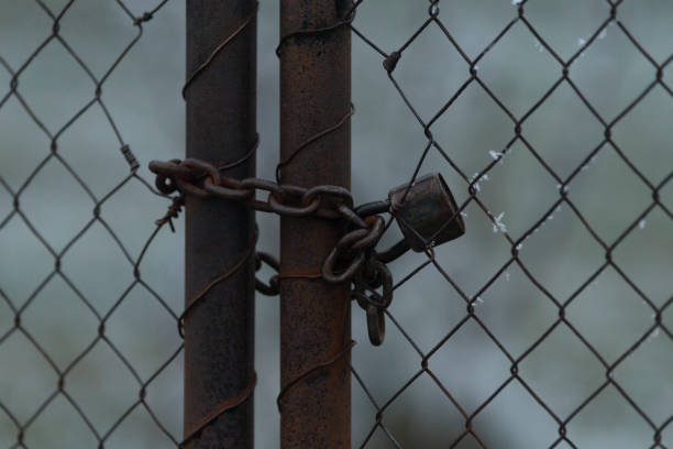 istock A Rusty Chain Padlock is fastened to Metal Fence Gates for security 2197881651
