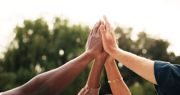 istock People, hands and high five with team in unity for collaboration, mission or solidarity in nature. Group, huddle and circle with motivation or inclusion for support, trust or community together 2197886149