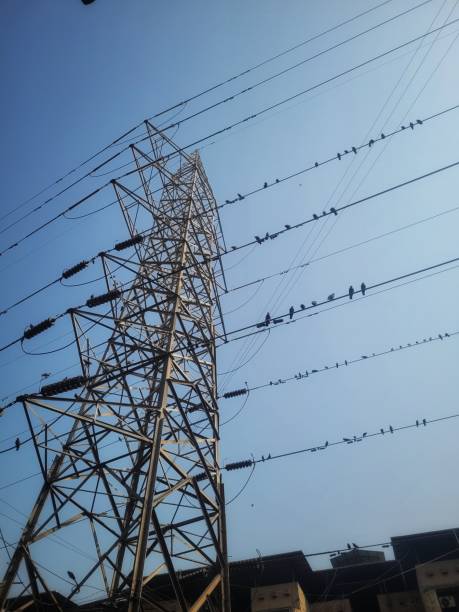 istock Tall electricity pylon against blue sky on sunny day 2197887245