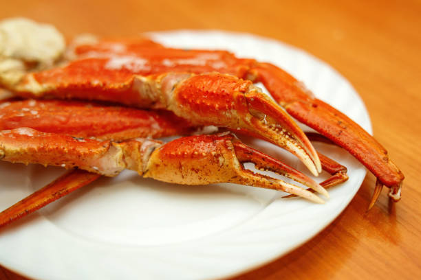 istock boiled crab claws and limbs arranged on a white ceramic plate, showcasing their vibrant color and texture, perfect for seafood culinary themes 2197888855