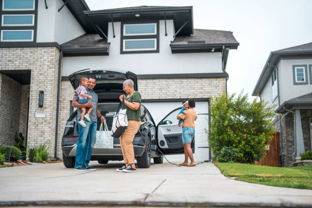 istock Multi-Generational Family by Eco-Friendly Home with Electric Car 2197891232