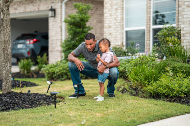istock Diverse Father and Son Team Installing Solar Lights 2197891263