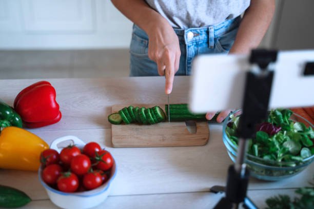 istock Girl chopping vegetables with joy in the kitchen 2197891631