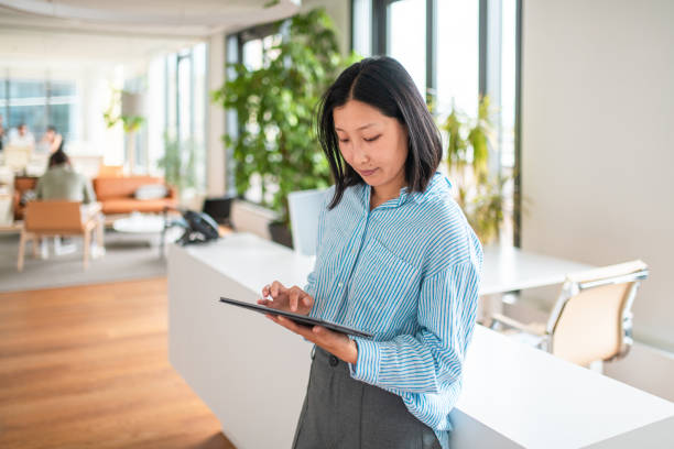 istock Professional Asian Businesswoman Using Tablet in Office 2197892854