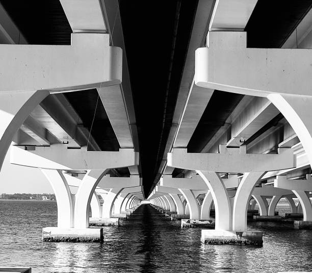 Pensacola bay, Florida. Historic three-mile bridge with it’s modern architecture, geometric symmetry in an urban landscape, shot in black and white.