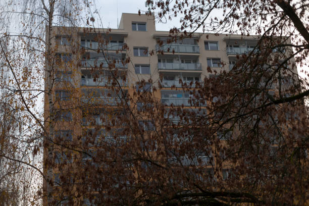 istock A tall building with many windows is surrounded by trees 2197894398