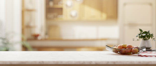 istock Minimalist white-marble kitchen island with decorative items set in in a minimalist, bright kitchen. 2197894498