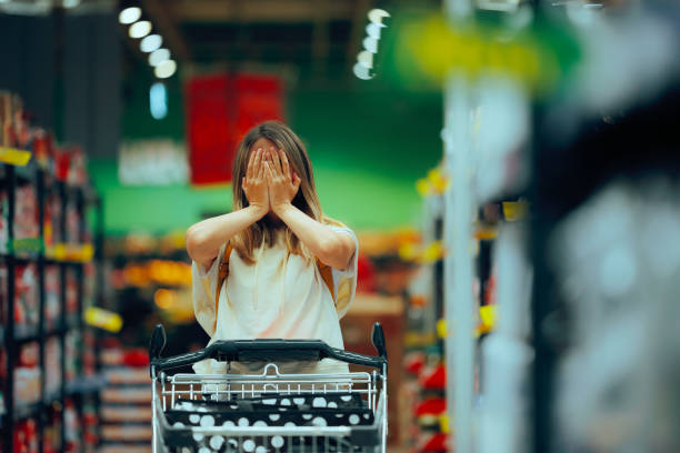 istock Stressed Shopper Covering her Face in a Supermarket 2197894709