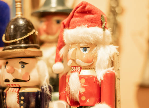 Christmas, nutcracker, Santa hat, wooden figurine, holiday decoration, festive season, traditional decor, winter, close-up, colorful, handmade, toy soldier, red uniform, Christmas market, festive spirit, holiday cheer, seasonal celebration, home decor, handcrafted, German tradition, ornaments, holiday craft, vintage style, decorative object, winter holidays, Christmas time, nostalgic, classic decor, red and white, Santa figure, holiday season, yuletide, Christmas spirit, family tradition, festive atmosphere, holiday festivity, Christmas toys, celebration, cultural tradition