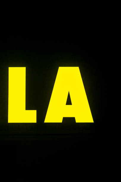 istock The word la is in bright yellow on a dark black background 2197896219