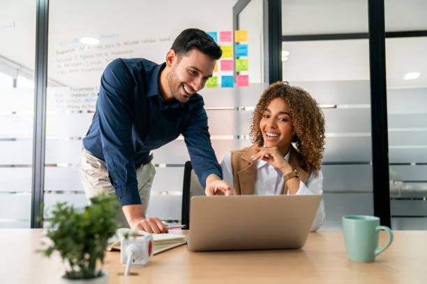 istock Happy business team working together at the office 2197896546