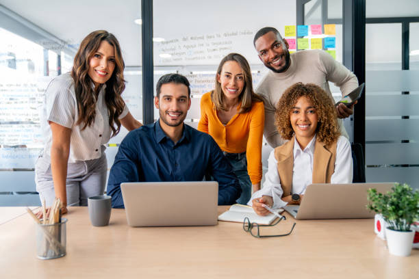 istock Happy group of workers smiling in a business meeting 2197896558