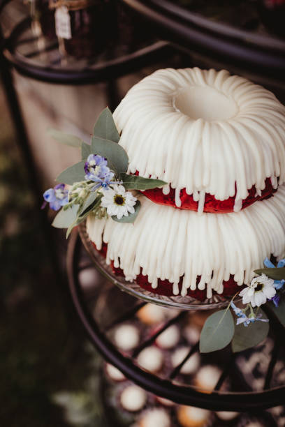 Red velvet bundt wedding cake with icing and flowers