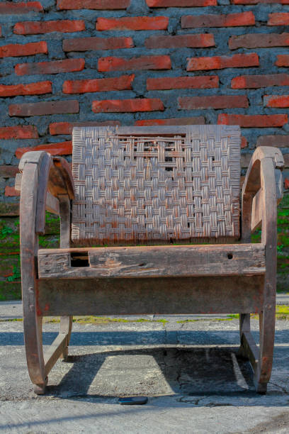 istock worn wooden chair brick wall background 2197897661