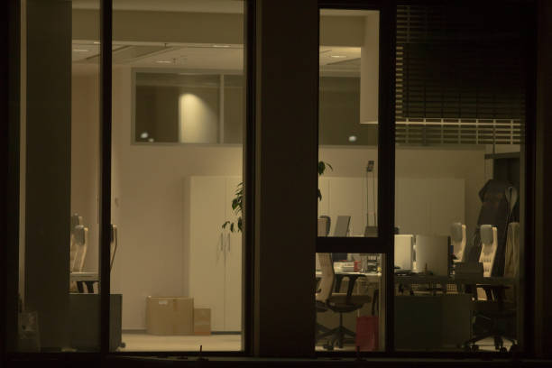 istock Office Building with Large Windows Viewed from Outside at Night 2197899744