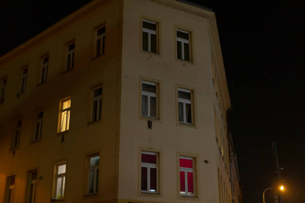 istock A tall building featuring numerous windows is brightly lit up at night 2197899783