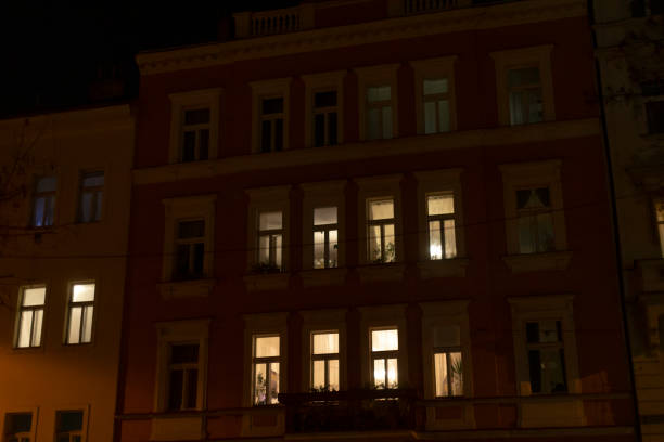 istock A large building that features numerous windows, shining brightly at night 2197899954