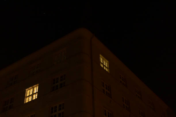 istock A tall, windowfilled condominium building is beautifully lit at night 2197900098